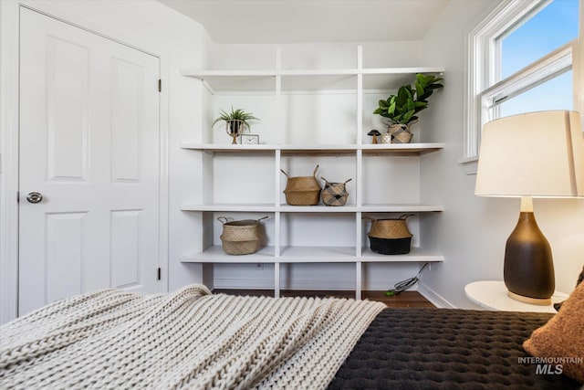 bedroom featuring baseboards and wood finished floors