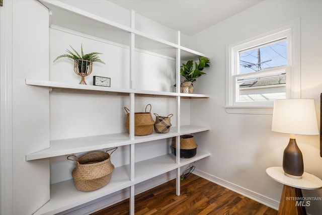 interior space featuring baseboards and wood finished floors