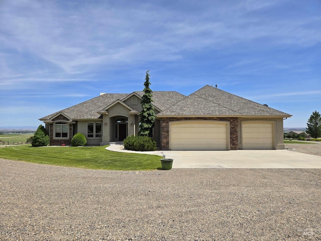 654 King Ave, Ontario, OR 97914 - ranch-style home with a garage, concrete driveway, a shingled roof, and a front lawn