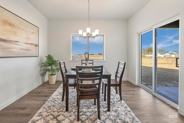 dining room with a notable chandelier, dark hardwood / wood-style floors, and a wealth of natural light