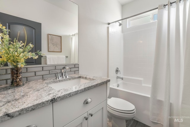 full bathroom featuring vanity, shower / bath combo, and toilet