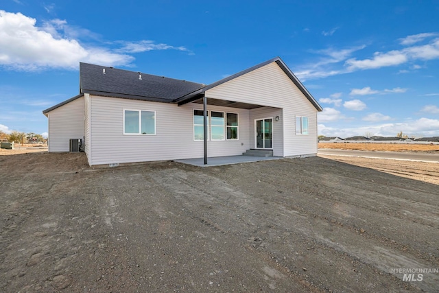 rear view of property with cooling unit and a patio area