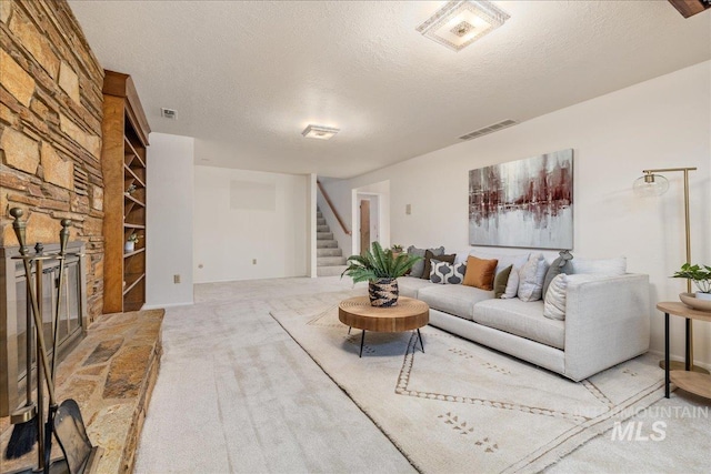 376 S Ravenswood Dr, Meridian, ID 83642 - carpeted living area with stairway, a textured ceiling, and a fireplace