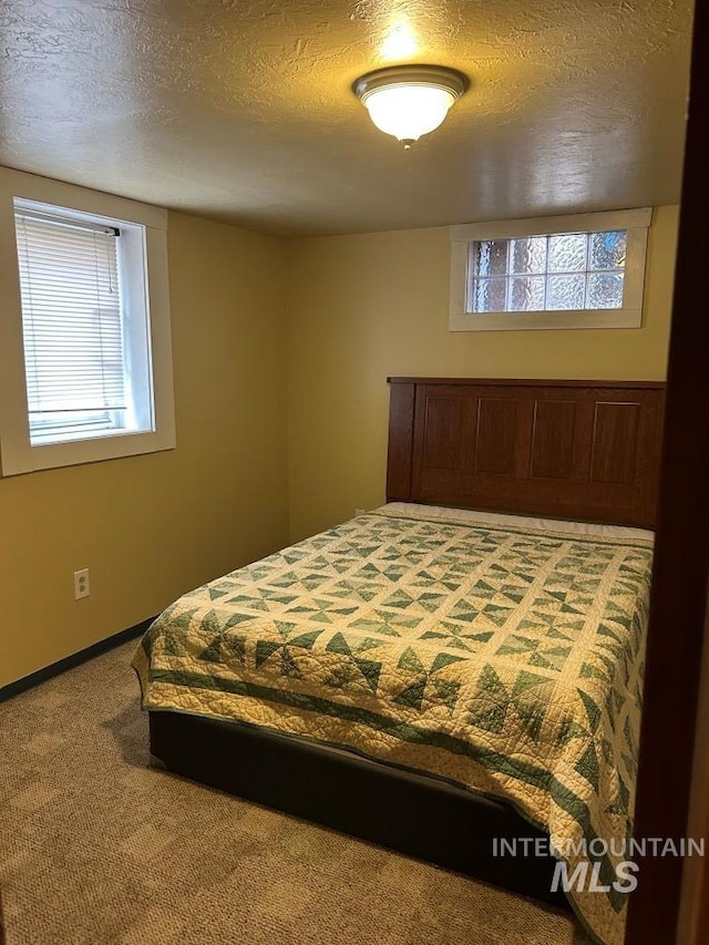 1527 13th Ave, Lewiston, ID 83501 - carpeted bedroom featuring a textured ceiling and baseboards