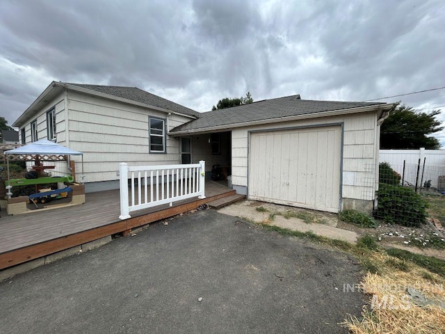 1527 13th Ave, Lewiston, ID 83501 - view of front of property with an attached garage, a wooden deck, asphalt driveway, and a shingled roof