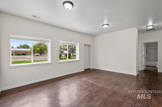 316 N 11th St, Payette, ID 83661 - spare room featuring wood finished floors and a textured ceiling
