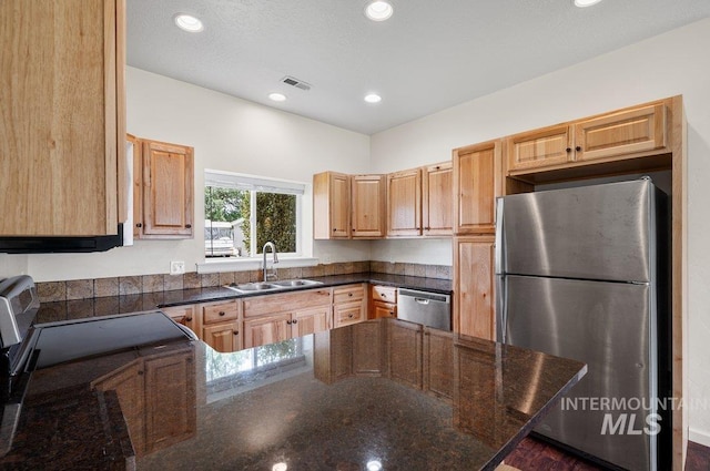 316 N 11th St, Payette, ID 83661 - kitchen featuring appliances with stainless steel finishes, a peninsula, recessed lighting, and dark stone countertops