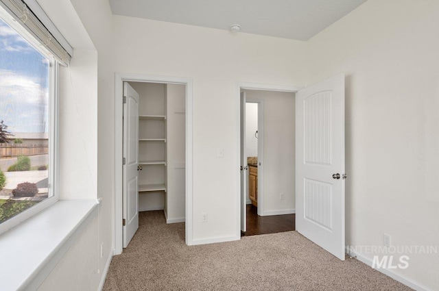 316 N 11th St, Payette, ID 83661 - unfurnished bedroom with carpet floors, a walk in closet, and a closet