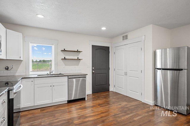 316 N 11th St, Payette, ID 83661 - kitchen featuring stainless steel appliances, dark wood-style flooring, white cabinetry, recessed lighting, and open shelves