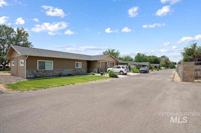 316 N 11th St, Payette, ID 83661 - view of front of home with a garage, stone siding, and driveway