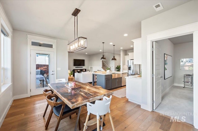 dining space with recessed lighting, visible vents, light wood-style floors, baseboards, and stairs