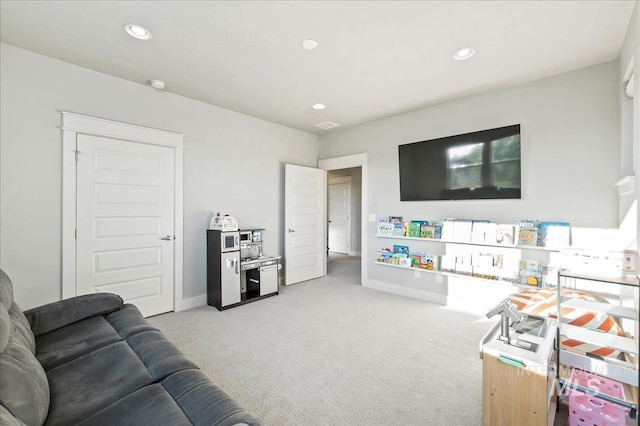 living area with light carpet, baseboards, and recessed lighting