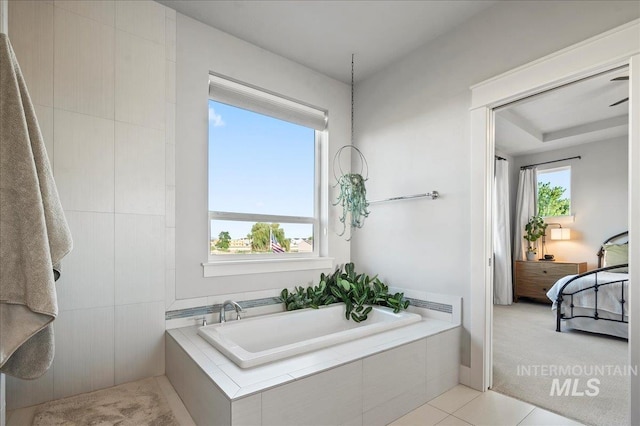 full bathroom featuring a bath, tile patterned flooring, ensuite bath, and a wealth of natural light