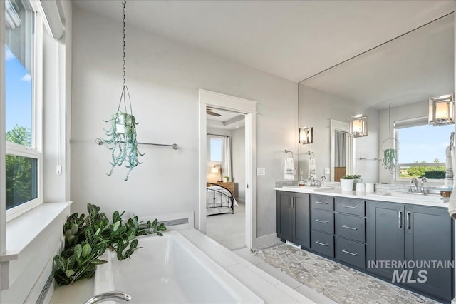 full bath featuring double vanity, a washtub, and a sink