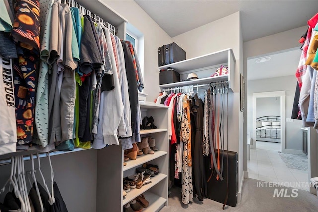 walk in closet featuring tile patterned flooring