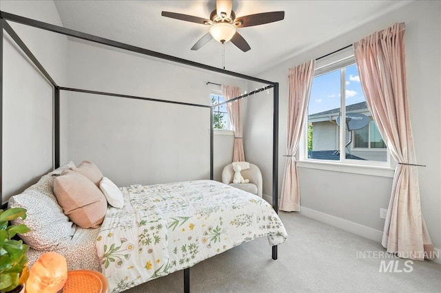 carpeted bedroom with baseboards and a ceiling fan