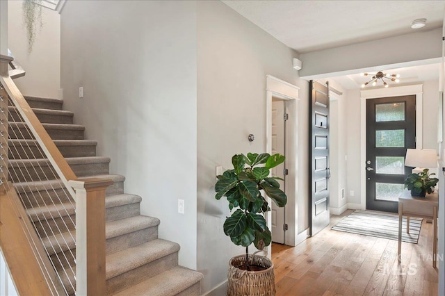 foyer featuring light wood-type flooring and stairway