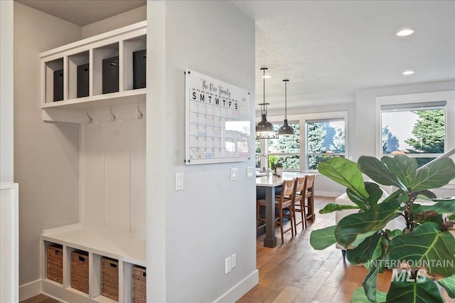 mudroom featuring baseboards, wood finished floors, and recessed lighting