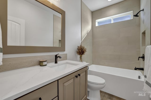 bathroom featuring toilet, tub / shower combination, and vanity