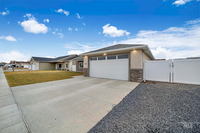 view of front of property with a garage, driveway, a gate, a front lawn, and stucco siding