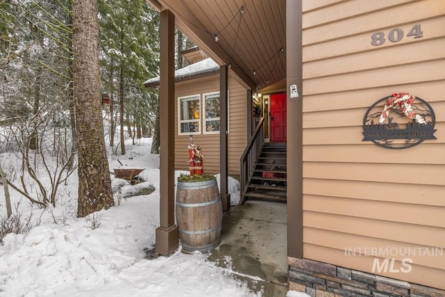 view of snow covered property entrance