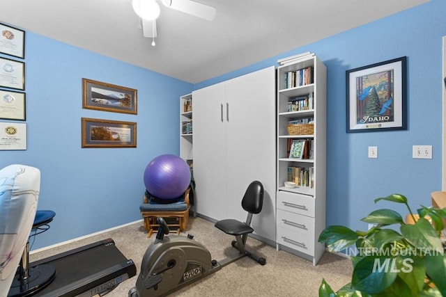 workout room featuring light carpet and ceiling fan