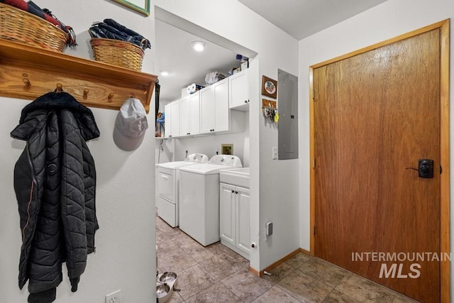 clothes washing area with electric panel, separate washer and dryer, and cabinets