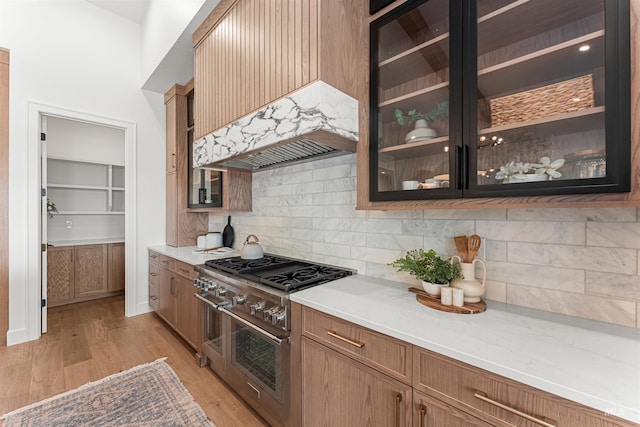 875 Creekwater, Eagle, ID 83616 - kitchen with double oven range, backsplash, light countertops, and glass insert cabinets