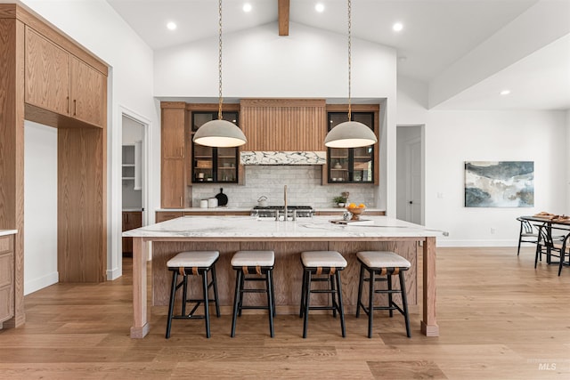 875 Creekwater, Eagle, ID 83616 - kitchen with decorative backsplash, a breakfast bar, high vaulted ceiling, beamed ceiling, and light wood-style floors