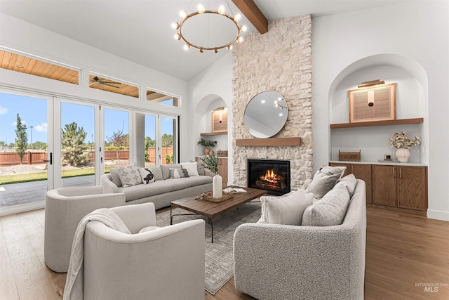 875 Creekwater, Eagle, ID 83616 - living room with wood finished floors, a fireplace, beam ceiling, a ceiling fan, and high vaulted ceiling