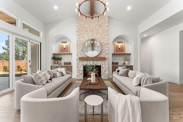875 Creekwater, Eagle, ID 83616 - living area featuring a stone fireplace, wood finished floors, high vaulted ceiling, and recessed lighting