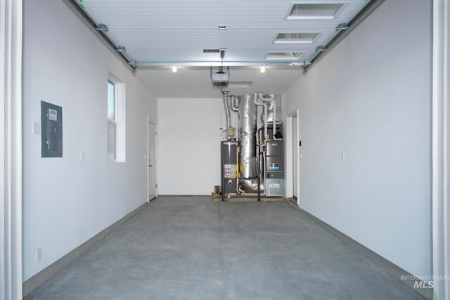 garage featuring a garage door opener, electric panel, and water heater