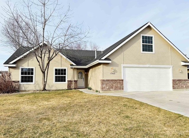 view of front of house with a garage, brick siding, concrete driveway, and a front lawn