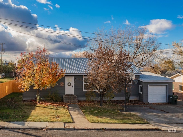 view of front of home featuring a garage and a front lawn