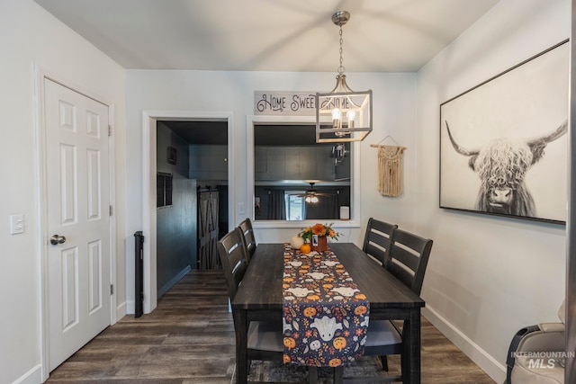 dining area with ceiling fan with notable chandelier and dark hardwood / wood-style flooring