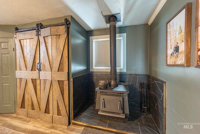 bathroom with a wood stove and tile walls