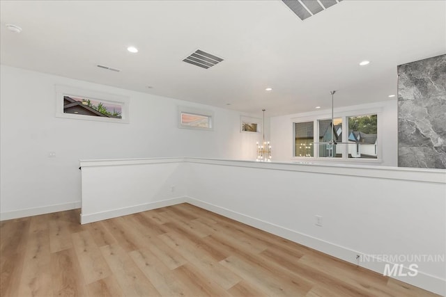 spare room with baseboards, light wood-style flooring, visible vents, and recessed lighting