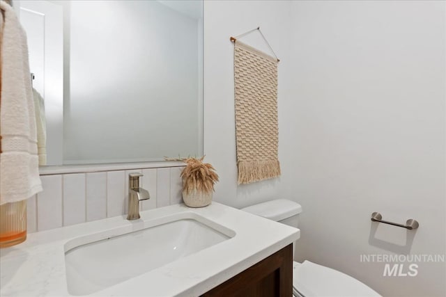 bathroom with toilet and vanity