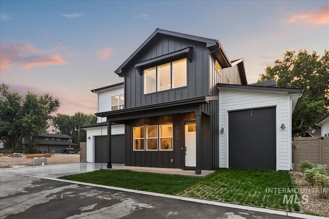 view of front of home featuring board and batten siding and concrete driveway