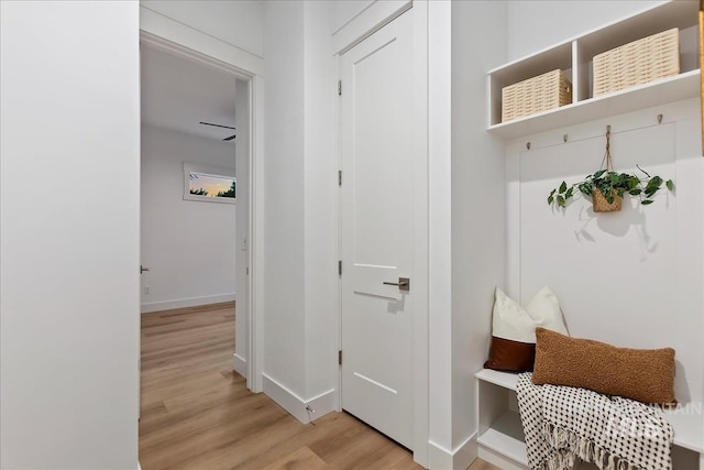 mudroom featuring baseboards and light wood finished floors