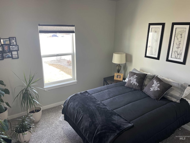 bedroom with baseboards and carpet flooring