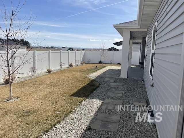 view of yard with a patio area and a fenced backyard