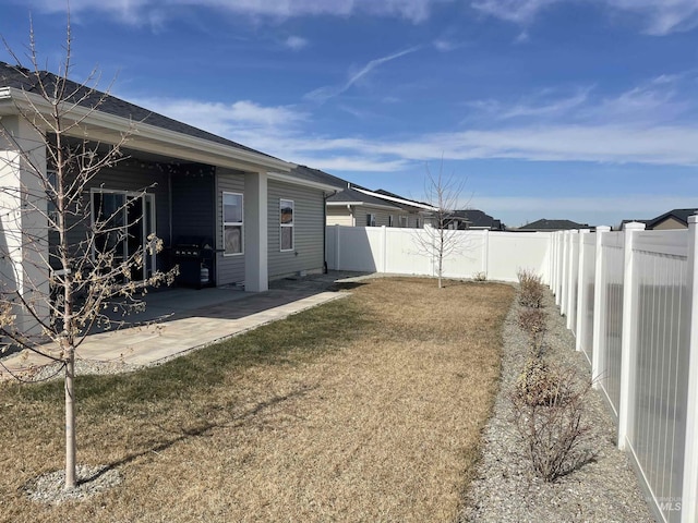 view of yard featuring a patio area and a fenced backyard