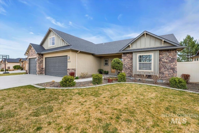 view of front of house with board and batten siding, a garage, stone siding, a front yard, and concrete driveway