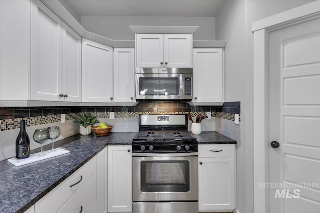 kitchen featuring appliances with stainless steel finishes, decorative backsplash, and white cabinetry