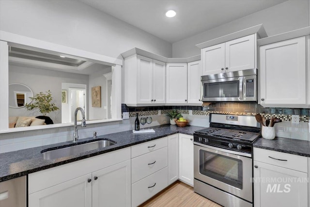 kitchen featuring a sink, white cabinets, and appliances with stainless steel finishes