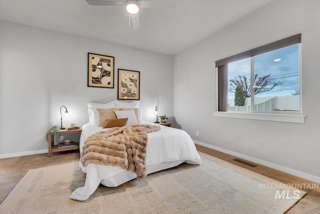 carpeted bedroom with visible vents, ceiling fan, and baseboards