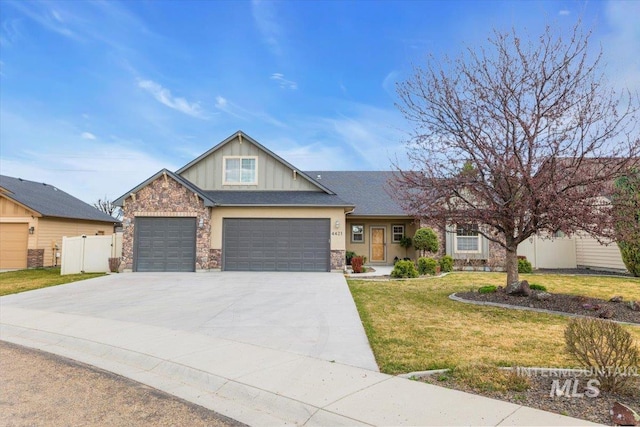 craftsman inspired home featuring board and batten siding, fence, a garage, driveway, and a front lawn