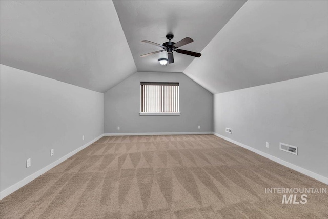 bonus room with a ceiling fan, visible vents, vaulted ceiling, baseboards, and carpet floors