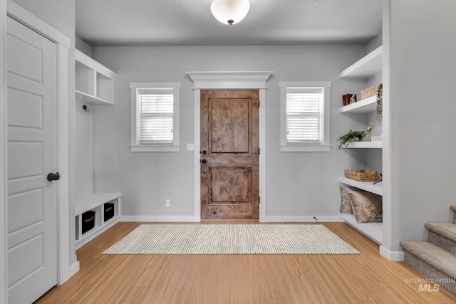 mudroom with baseboards and wood finished floors